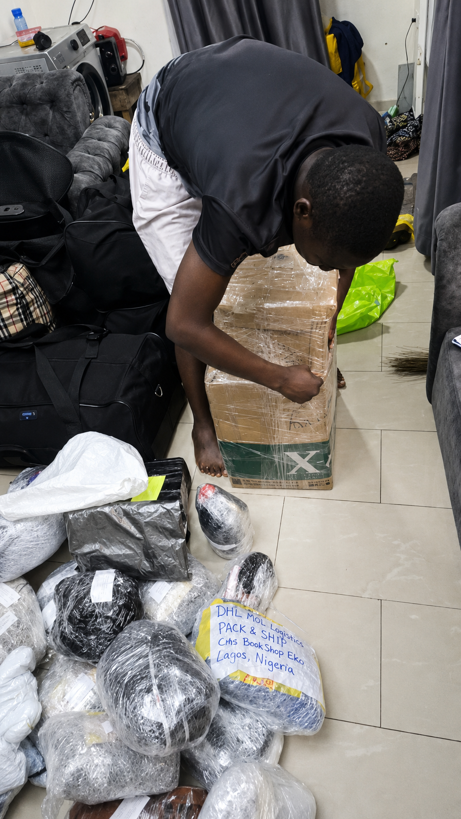 MO Logistics staff packing customer parcels at Lagos Nigeria warehouse
